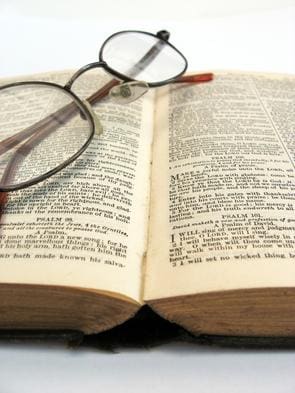closeup photograph of a book and glasses