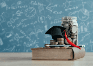 Graduation cap on books with coins and jar symbolizing education savings.