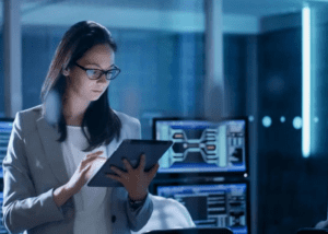 Woman using a tablet in a high-tech office environment.