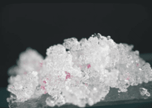 Close-up of sparkling ice crystals with a hint of pink.