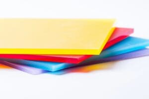 Stack of colorful translucent plastic sheets on a white surface.