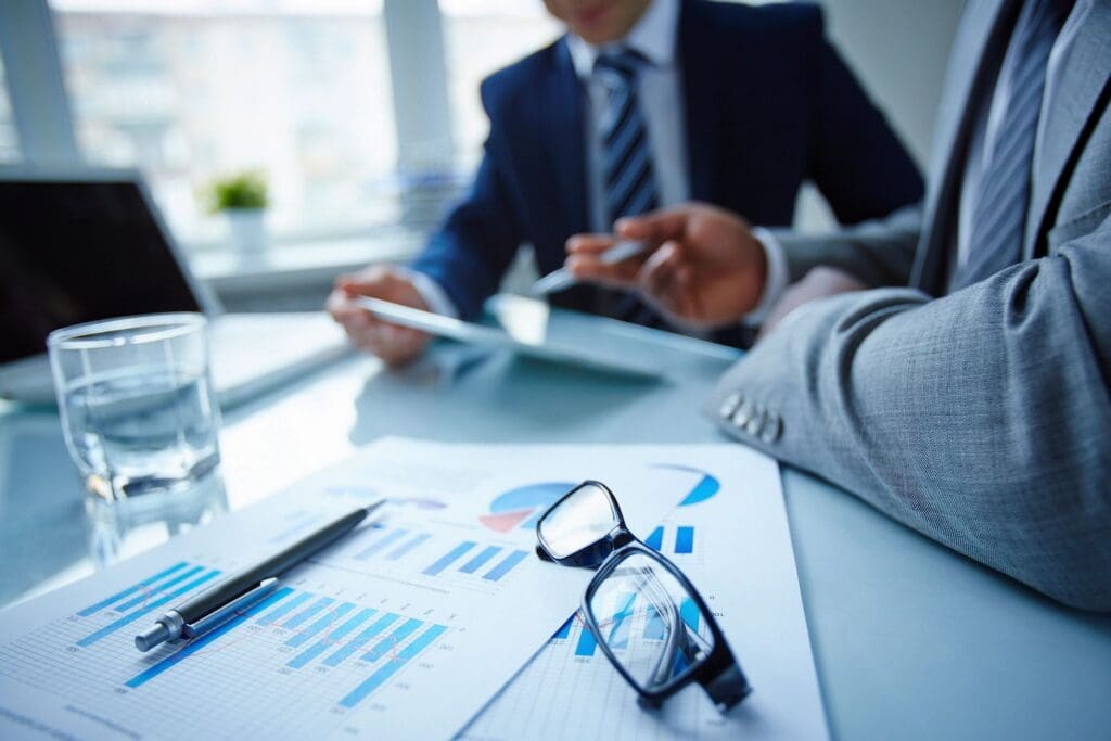 Business professionals discussing financial reports together.