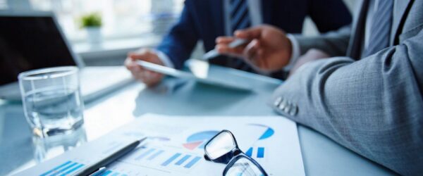 Business professionals discussing financial reports together.