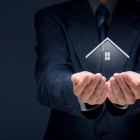 A person holding a digital house icon